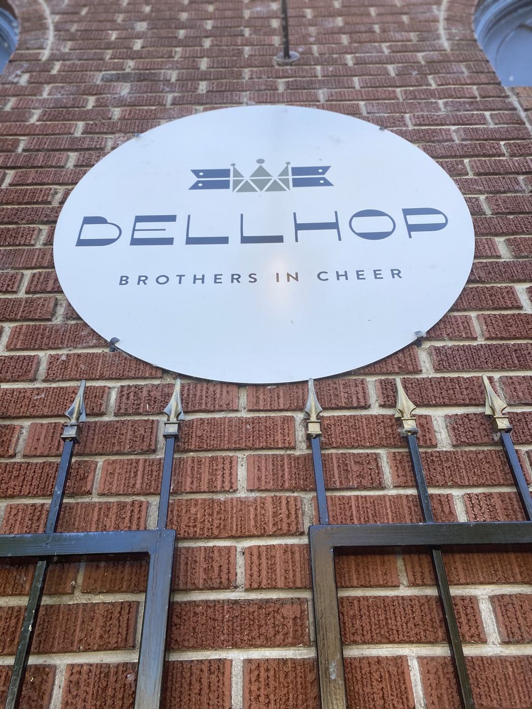 The round Bellhop Brothers in Cheer sign on the brick facade