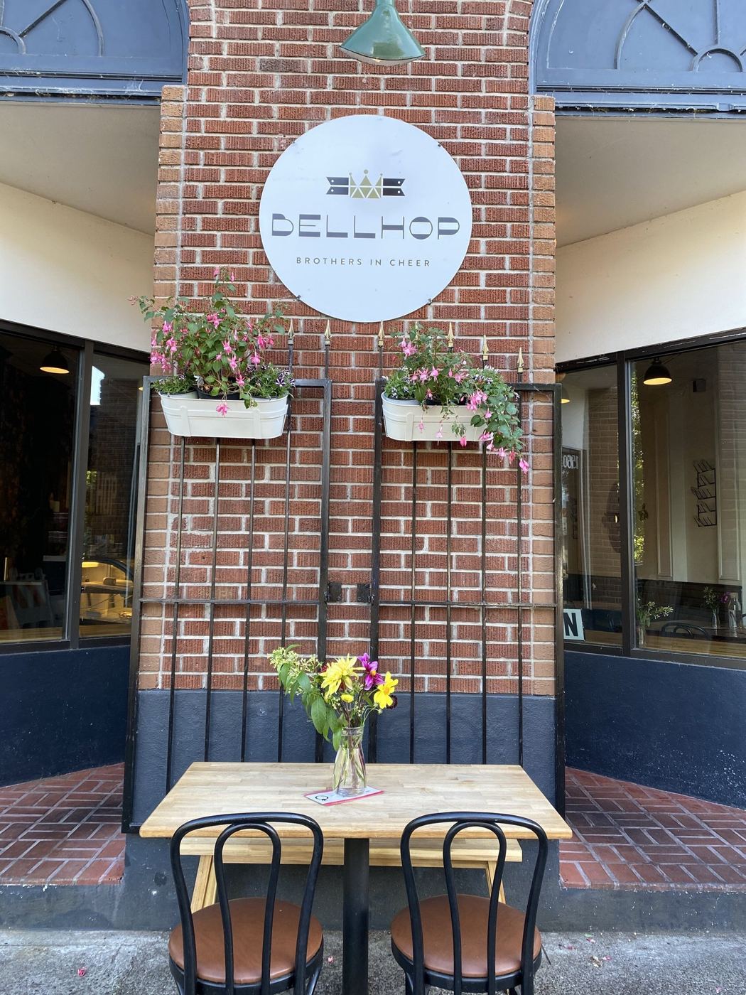 The Bellhop storefront and patio table on SW Madison Ave