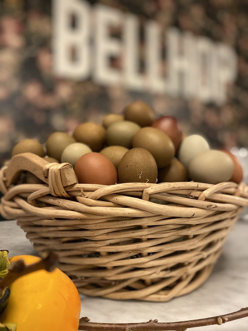 A basket of potatoes in front of the Bellhop sign